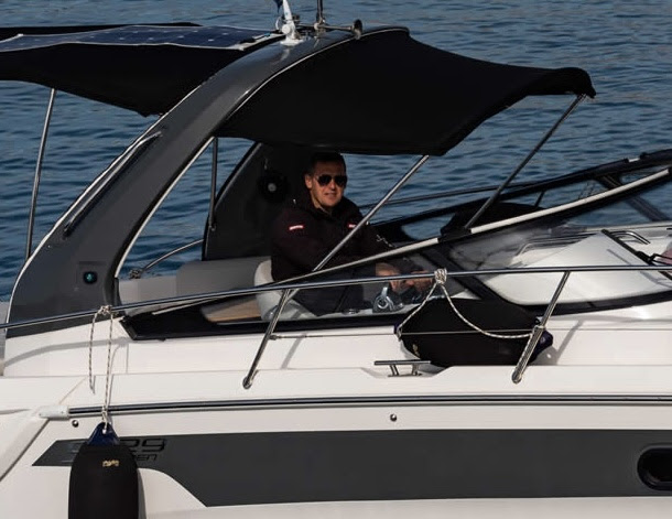 person steering motorboat